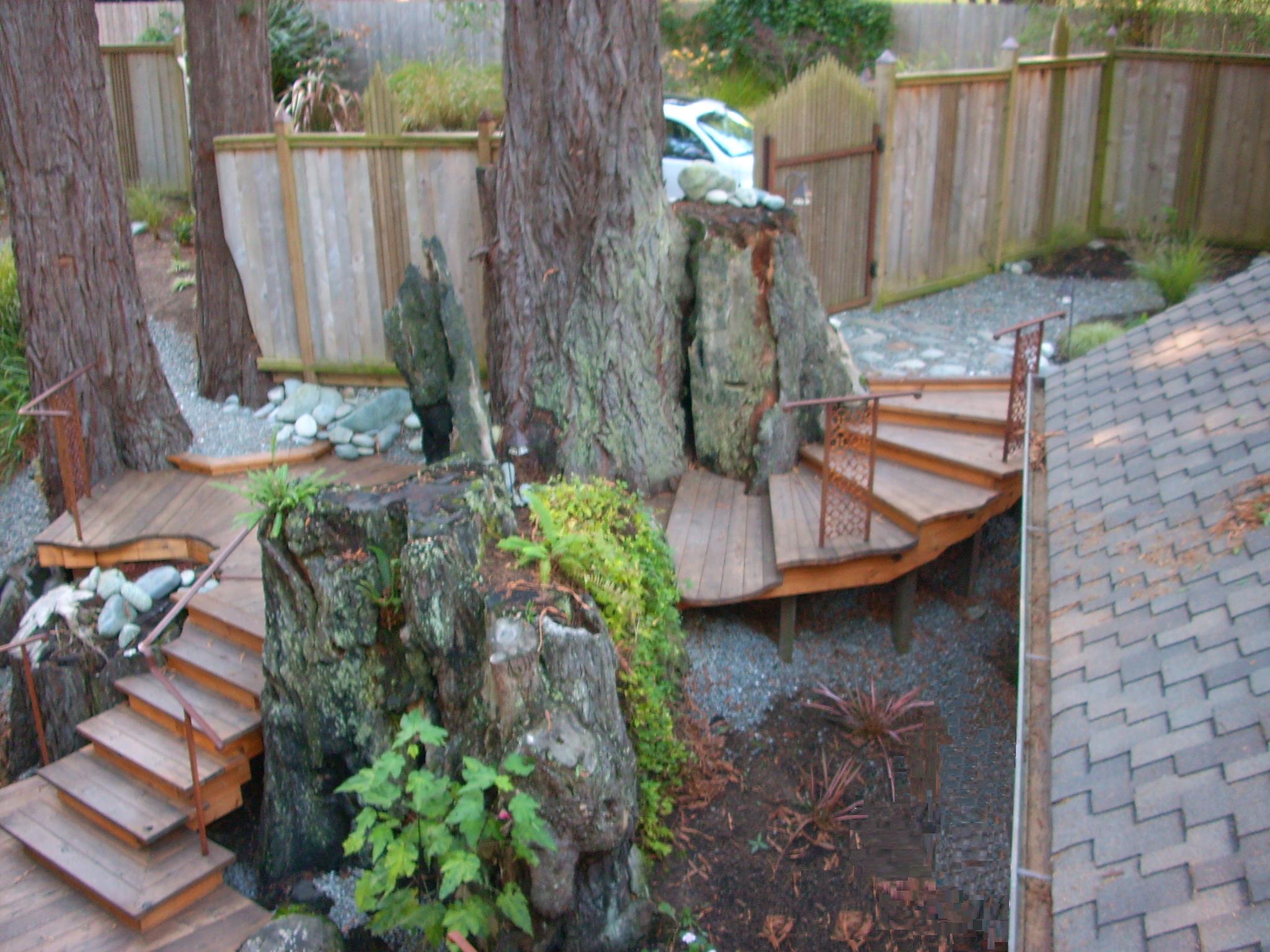 Finished elevated wood deck built around mature trees and rock outcroppings